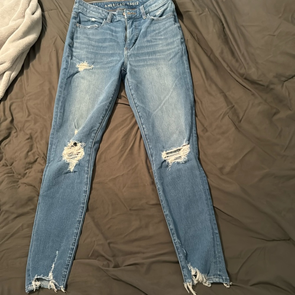 Stretchy blue jeans with rips and holes